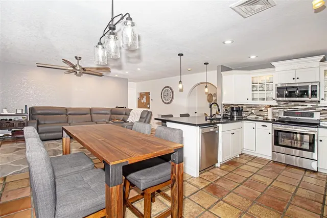 a bedroom with a bed and a chair with the wooden floor