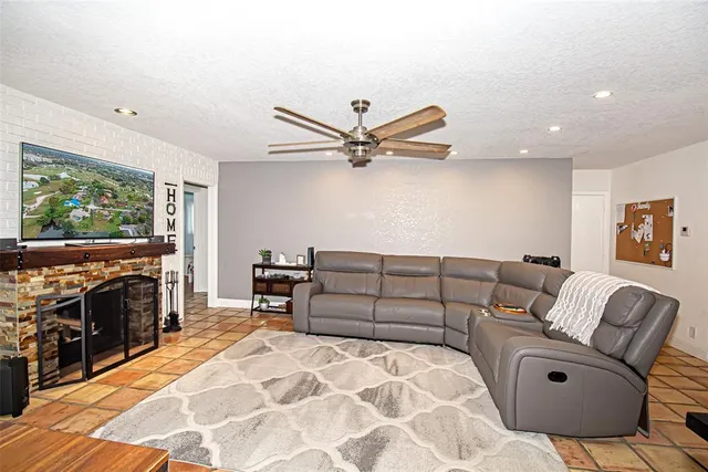 a bathroom with a granite countertop toilet a sink and shower