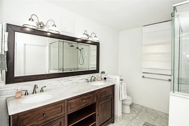 an aerial view of residential houses with outdoor space and street view