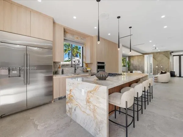 a kitchen with stainless steel appliances kitchen island a large island in the center