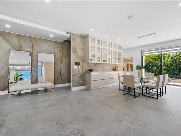a living room with furniture and white furniture