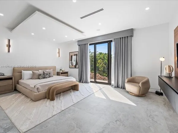 a spacious bedroom with a bed and a couch