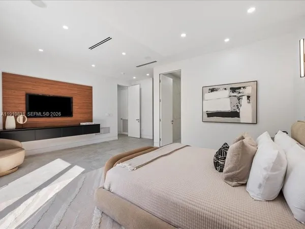 a bedroom with a bed and a television