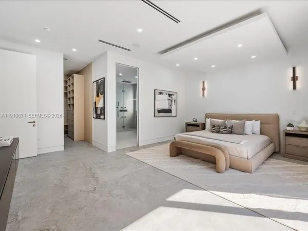 a spacious bedroom with a bed a couch and a view living room