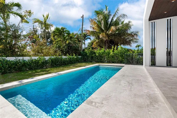 a view of a swimming pool with a yard