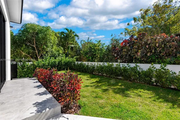 a front view of house with yard and outdoor seating