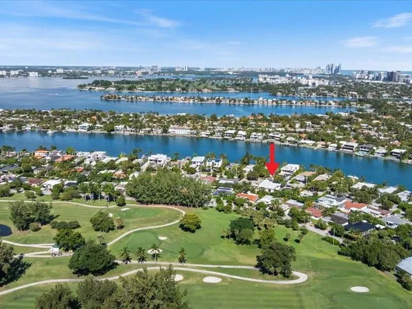 an aerial view of lake and residential houses with outdoor space