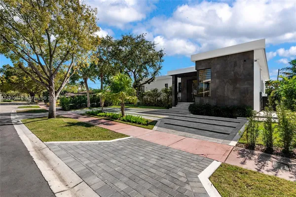 a view of a yard with plants and a fire pit
