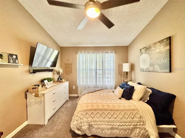 a spacious bedroom with a bed and a chandelier