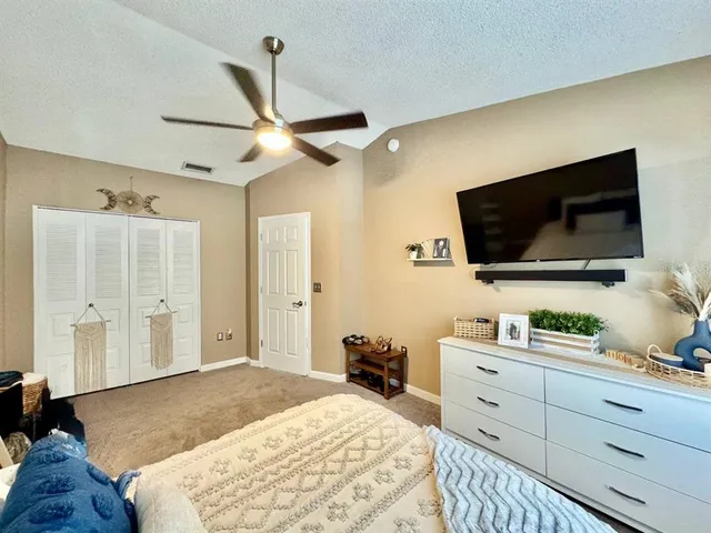 a bedroom with a bed and a flat screen tv
