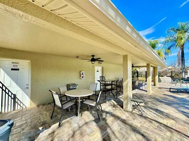 a dining room with furniture and a potted plant