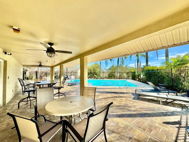 a view of a swimming pool with a table and chairs