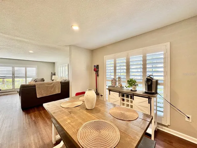 a view of a dining room with furniture and wooden floor