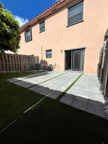 a view of house with backyard and wooden fence