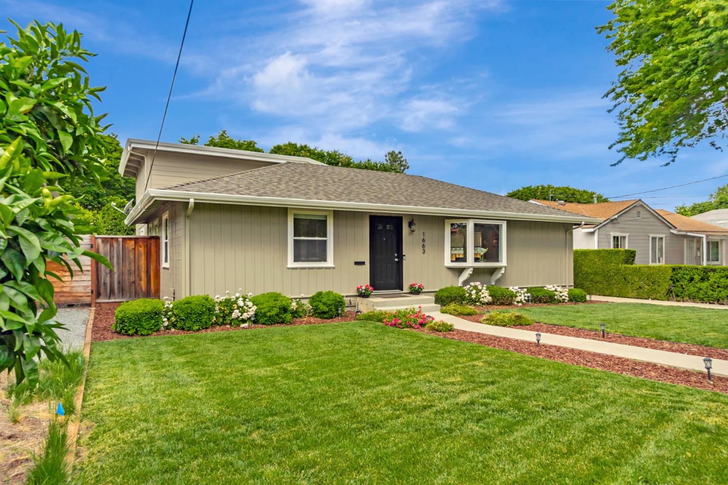 a front view of house with yard and green space
