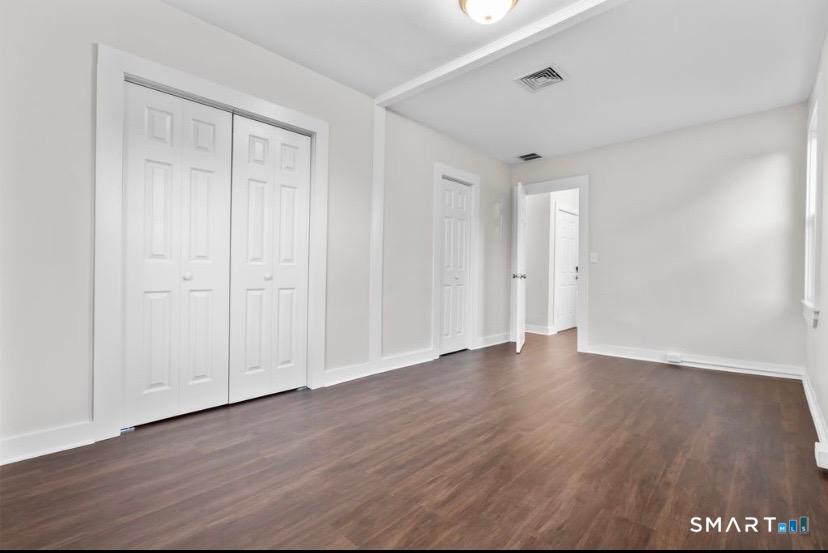 57 East Main Street, Unit 2 Branford, CT 06405 - Photo 11 of 17 a view of an empty room with wooden floor