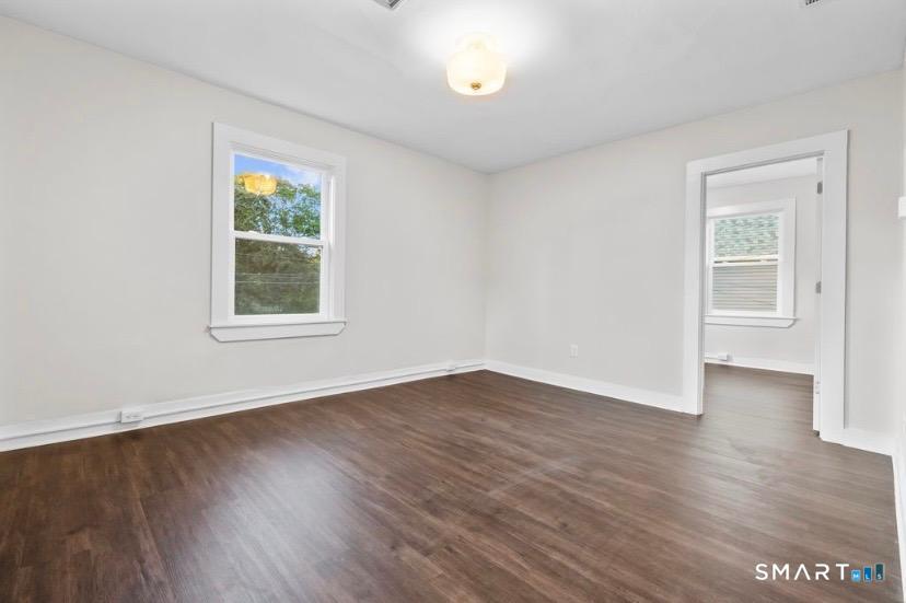 57 East Main Street, Unit 2 Branford, CT 06405 - Photo 13 of 17 an empty room with wooden floor and windows