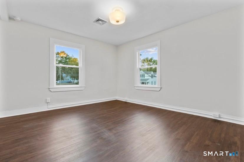 57 East Main Street, Unit 2 Branford, CT 06405 - Photo 14 of 17 a view of an empty room with wooden floor and a window