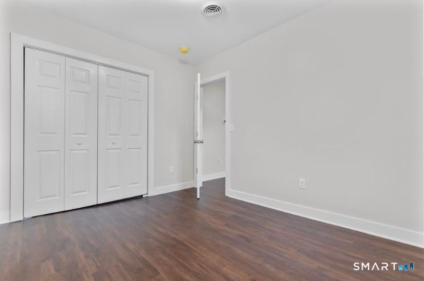 57 East Main Street, Unit 2 Branford, CT 06405 - Photo 16 of 17 a view of an empty room with wooden floor