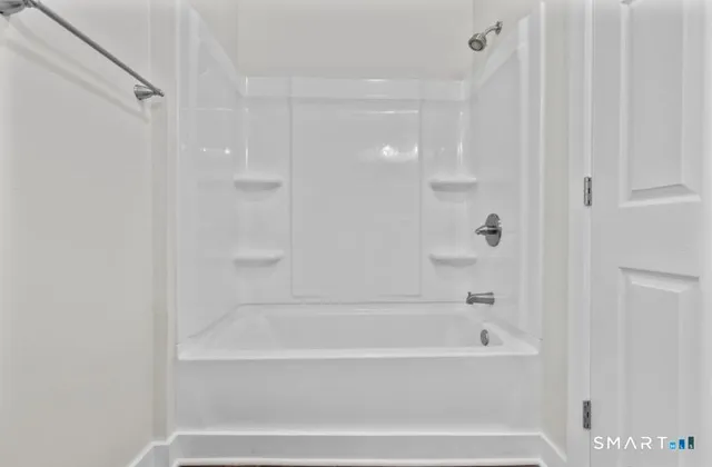 a bathroom with bathtub and shower