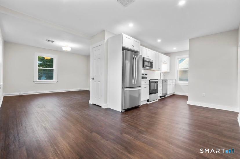 57 East Main Street, Unit 2 Branford, CT 06405 - Photo 8 of 17 a view of a kitchen with a fridge wooden floor and a window