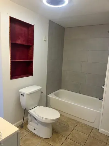 a bathroom with a toilet a sink and bathtub