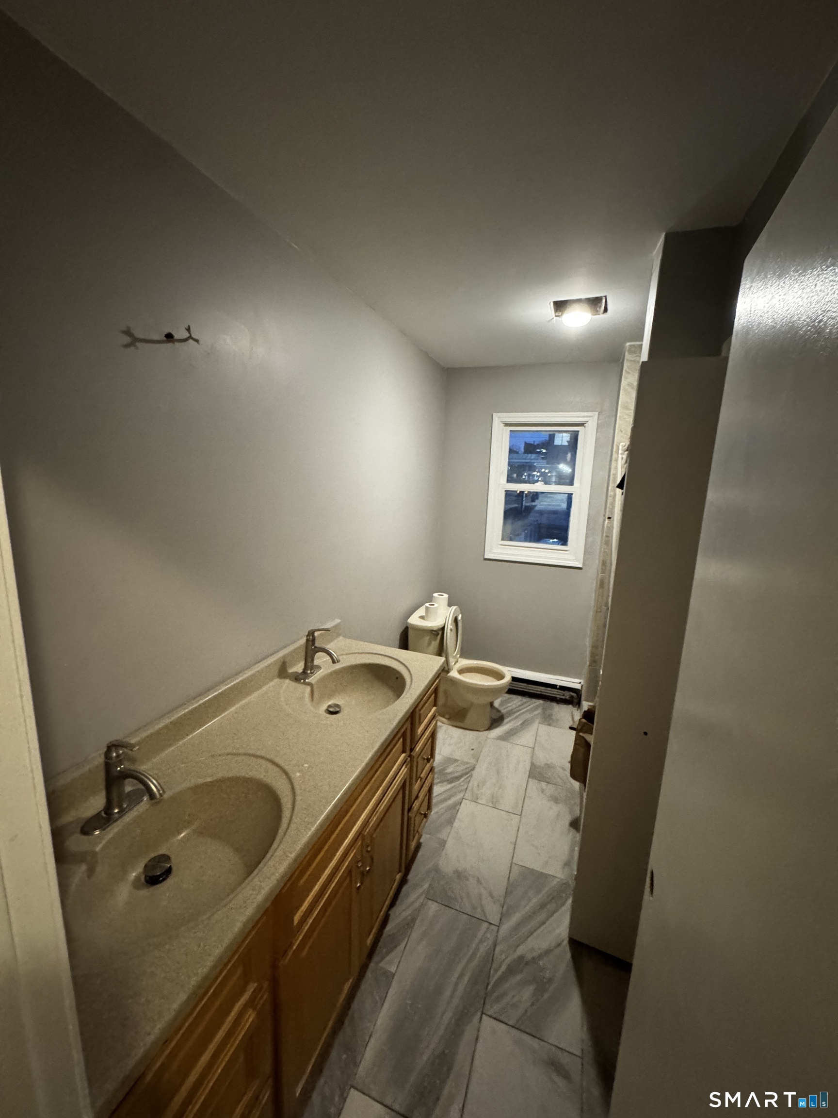 157 Anson Street Bridgeport, CT 06606 - Photo 2 of 5 a bathroom with a tub sink and mirror
