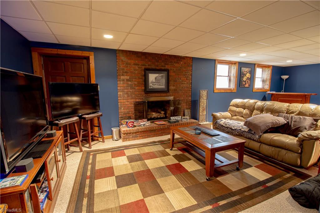 325 South Edgewood Road Eden, NC 27288 - Photo 19 of 29 man cave in finished basement with fireplace and gas logs
