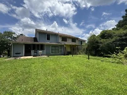 a front view of house with yard and green space