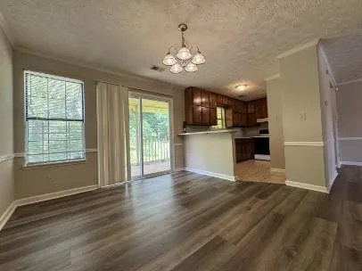 a view of a kitchen with a stove wooden floor and a kitchen