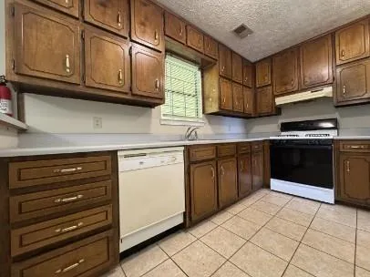 a kitchen with stainless steel appliances granite countertop a stove and cabinets