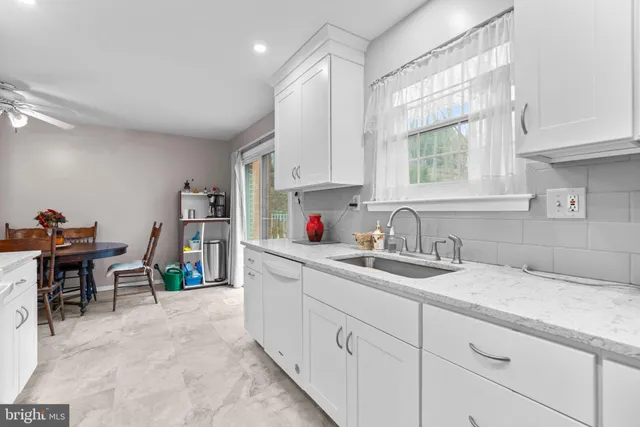 a kitchen with sink cabinets and a window