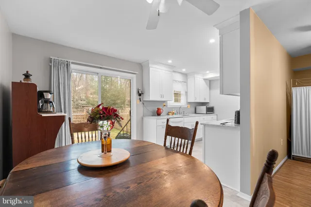 a dining room with furniture a window and kitchen view