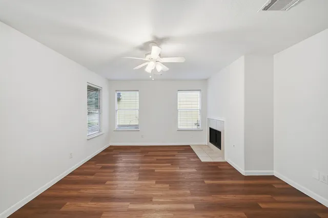 wooden floor in an empty room with a window