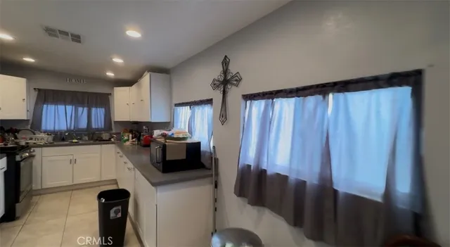 a kitchen with stainless steel appliances a stove a sink dishwasher and a refrigerator