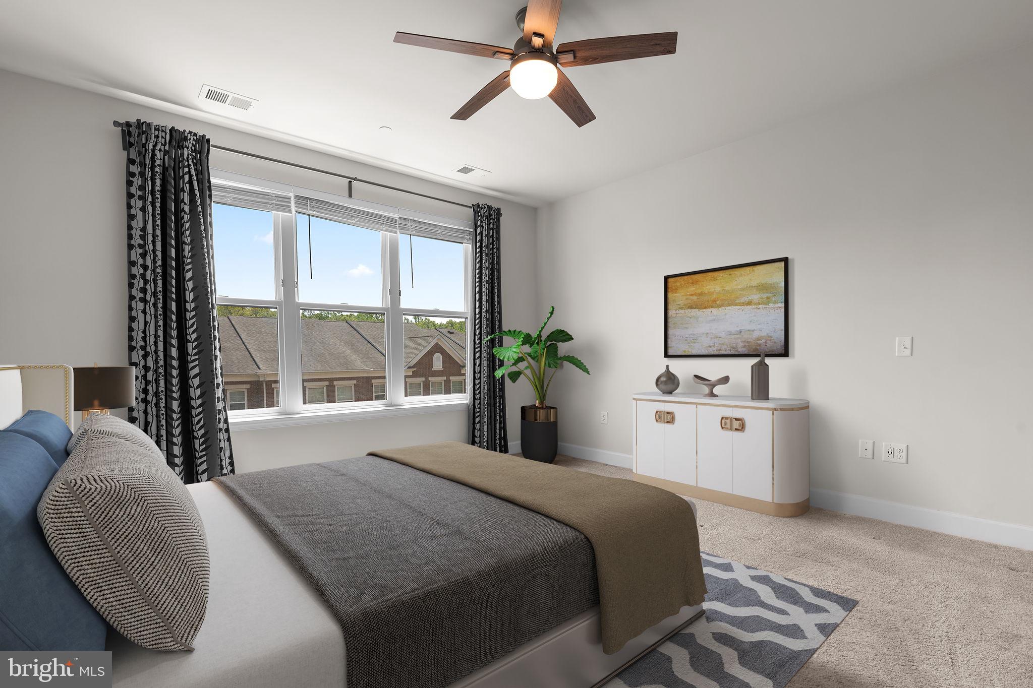 2960 Vaden Drive, Unit 2312 Fairfax, VA 22031 - Photo 12 of 46 a bedroom with a bed and a flat screen tv