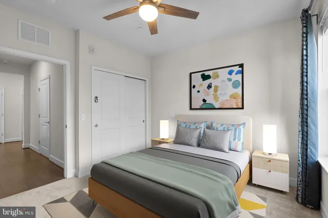 a bedroom with a bed and a painting on the wall