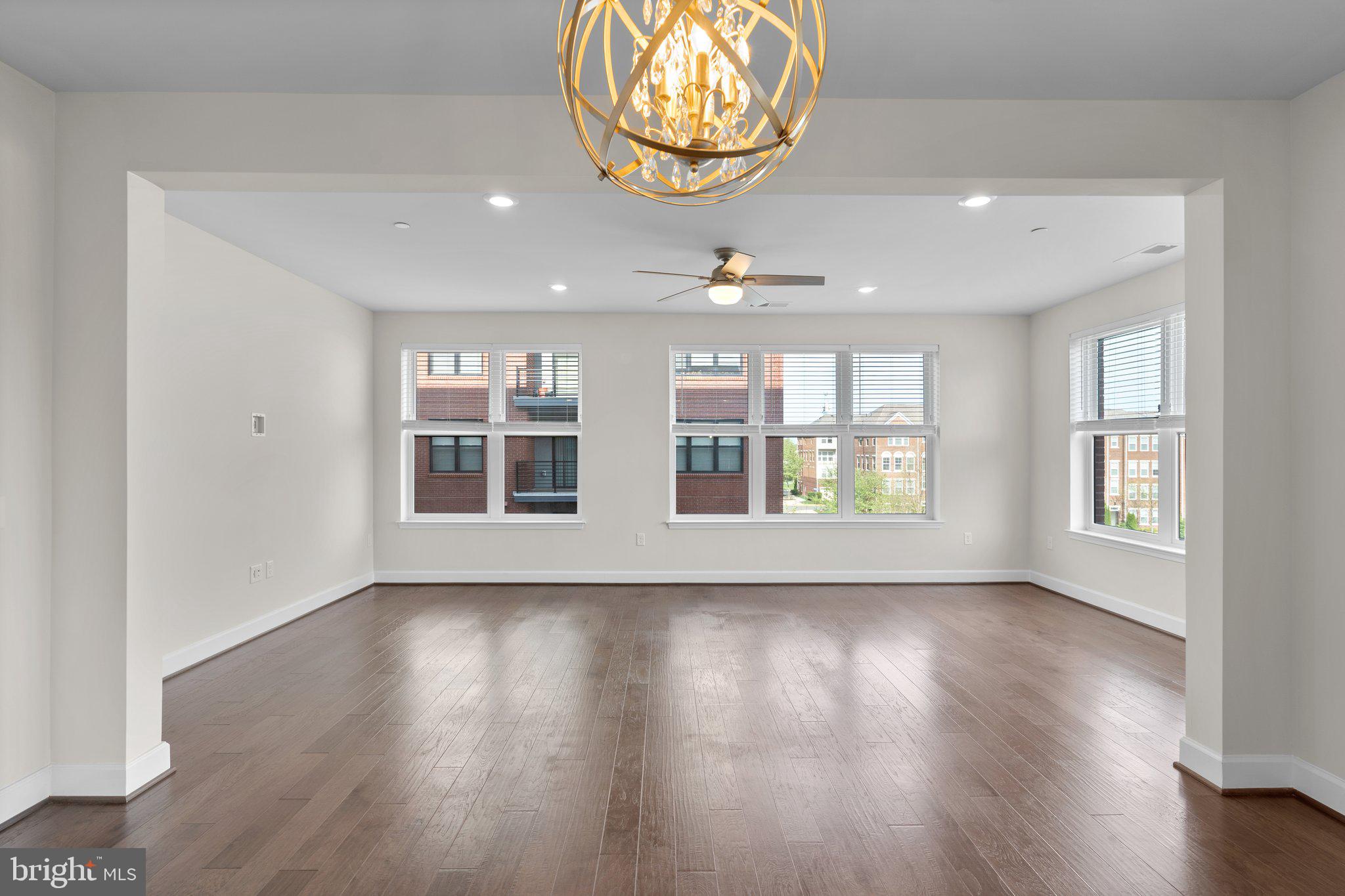 2960 Vaden Drive, Unit 2312 Fairfax, VA 22031 - Photo 16 of 46 a view of an empty room with wooden floor and a window