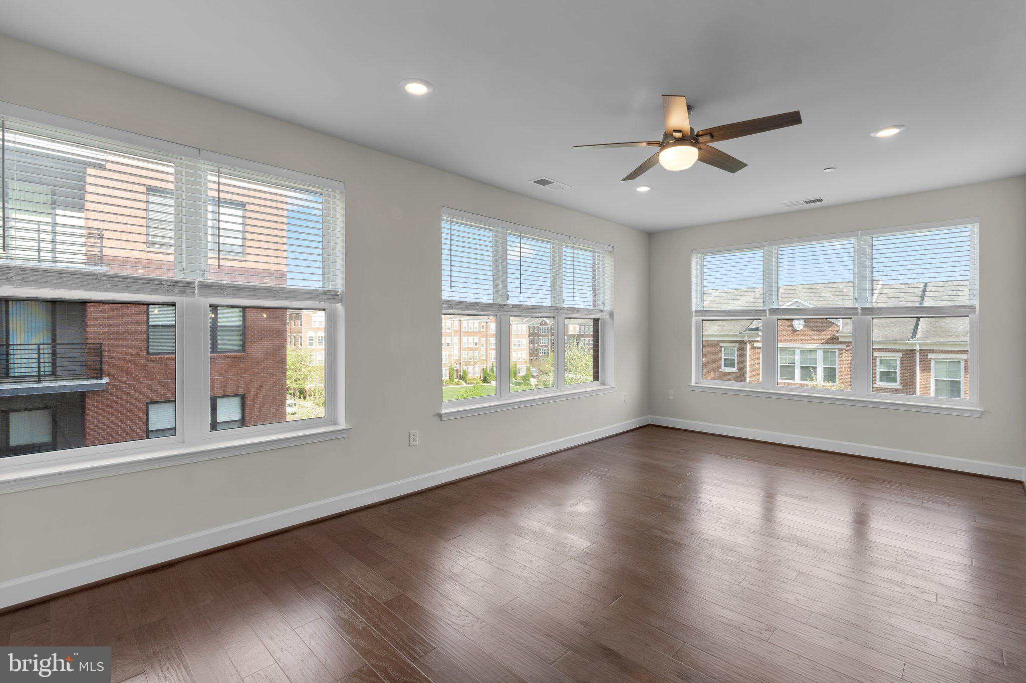 2960 Vaden Drive, Unit 2312 Fairfax, VA 22031 - Photo 17 of 46 a view of an empty room with wooden floor and a window