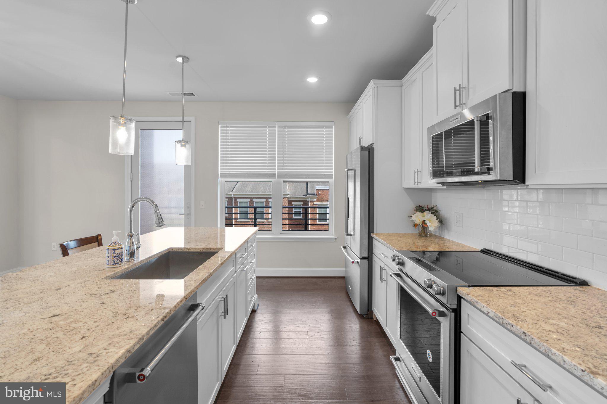 2960 Vaden Drive, Unit 2312 Fairfax, VA 22031 - Photo 23 of 46 a kitchen with stainless steel appliances granite countertop a sink stove and refrigerator