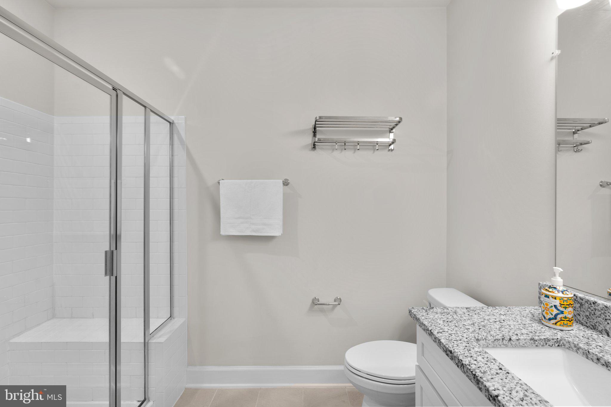 2960 Vaden Drive, Unit 2312 Fairfax, VA 22031 - Photo 32 of 46 a bathroom with a granite countertop sink toilet and shower