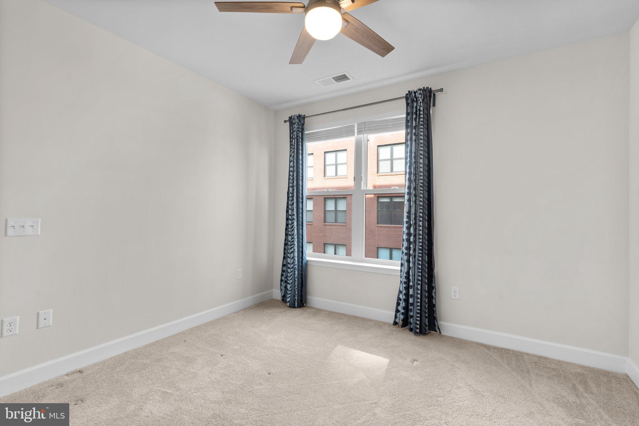 2960 Vaden Drive, Unit 2312 Fairfax, VA 22031 - Photo 33 of 46 an empty room with a window and a ceiling fan