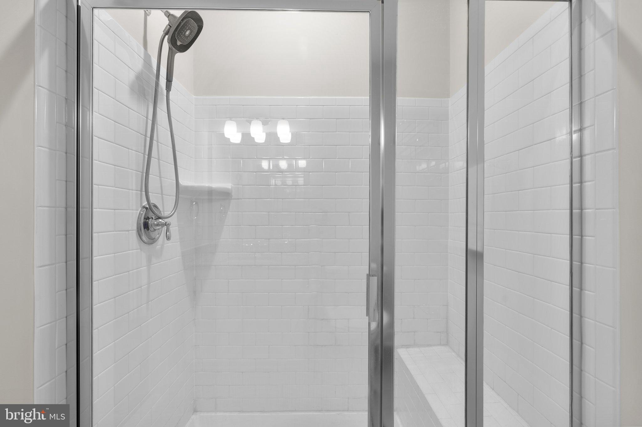 2960 Vaden Drive, Unit 2312 Fairfax, VA 22031 - Photo 35 of 46 a bathroom with a glass shower door