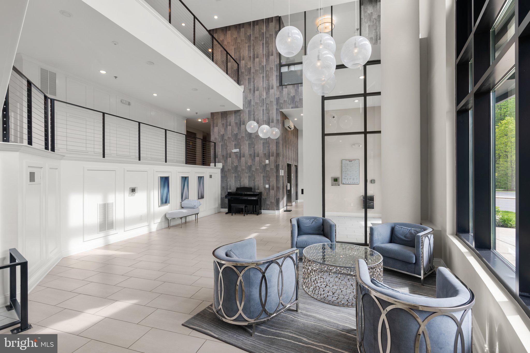 2960 Vaden Drive, Unit 2312 Fairfax, VA 22031 - Photo 43 of 46 a living room with furniture a large window and a chandelier