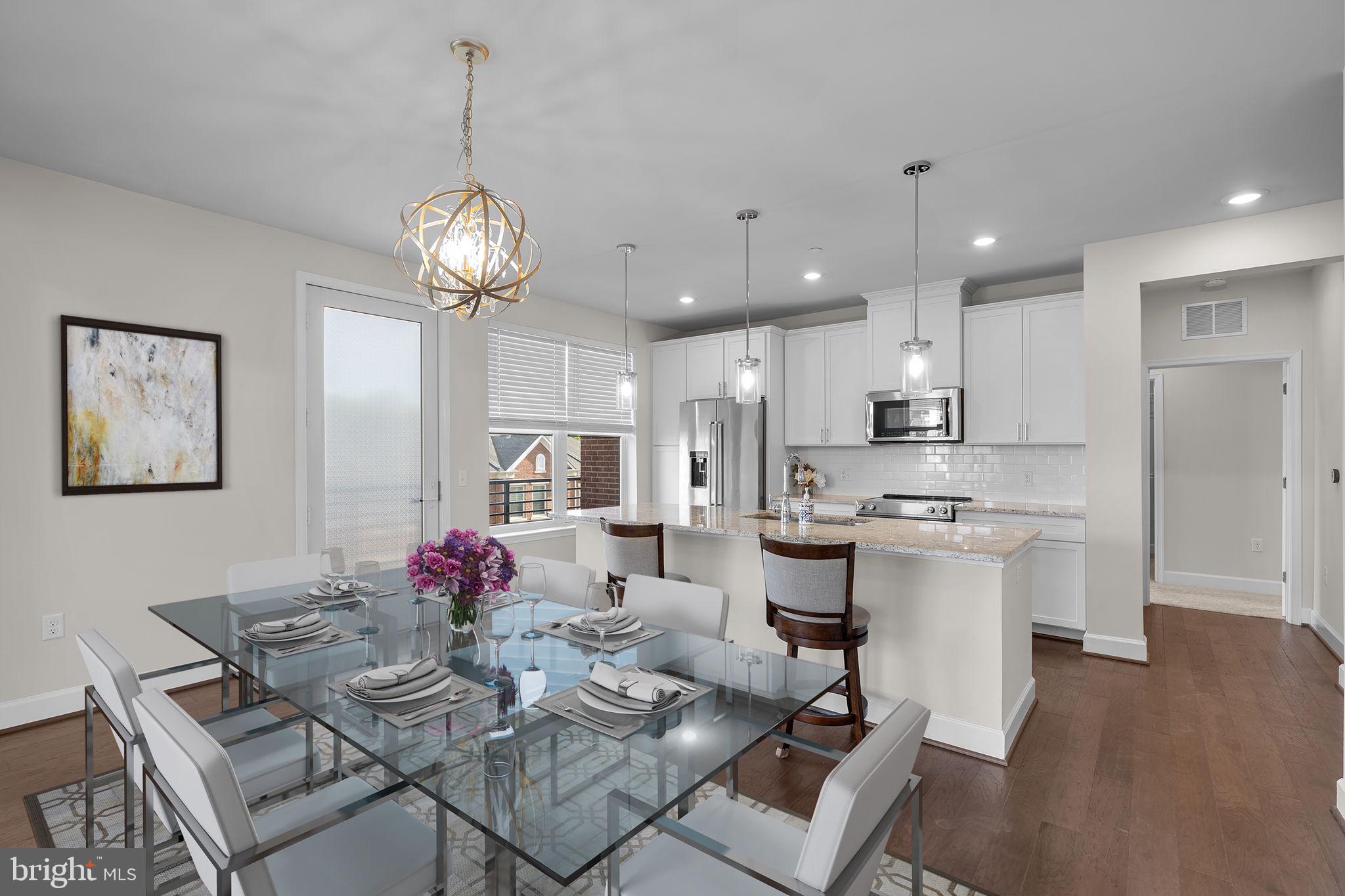 2960 Vaden Drive, Unit 2312 Fairfax, VA 22031 - Photo 7 of 46 a view of a dining room with furniture and wooden floor