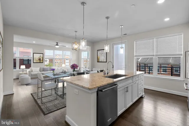 a kitchen with stainless steel appliances granite countertop a stove and a wooden floors