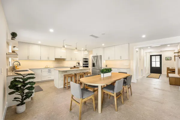 a kitchen with a table and chairs in it