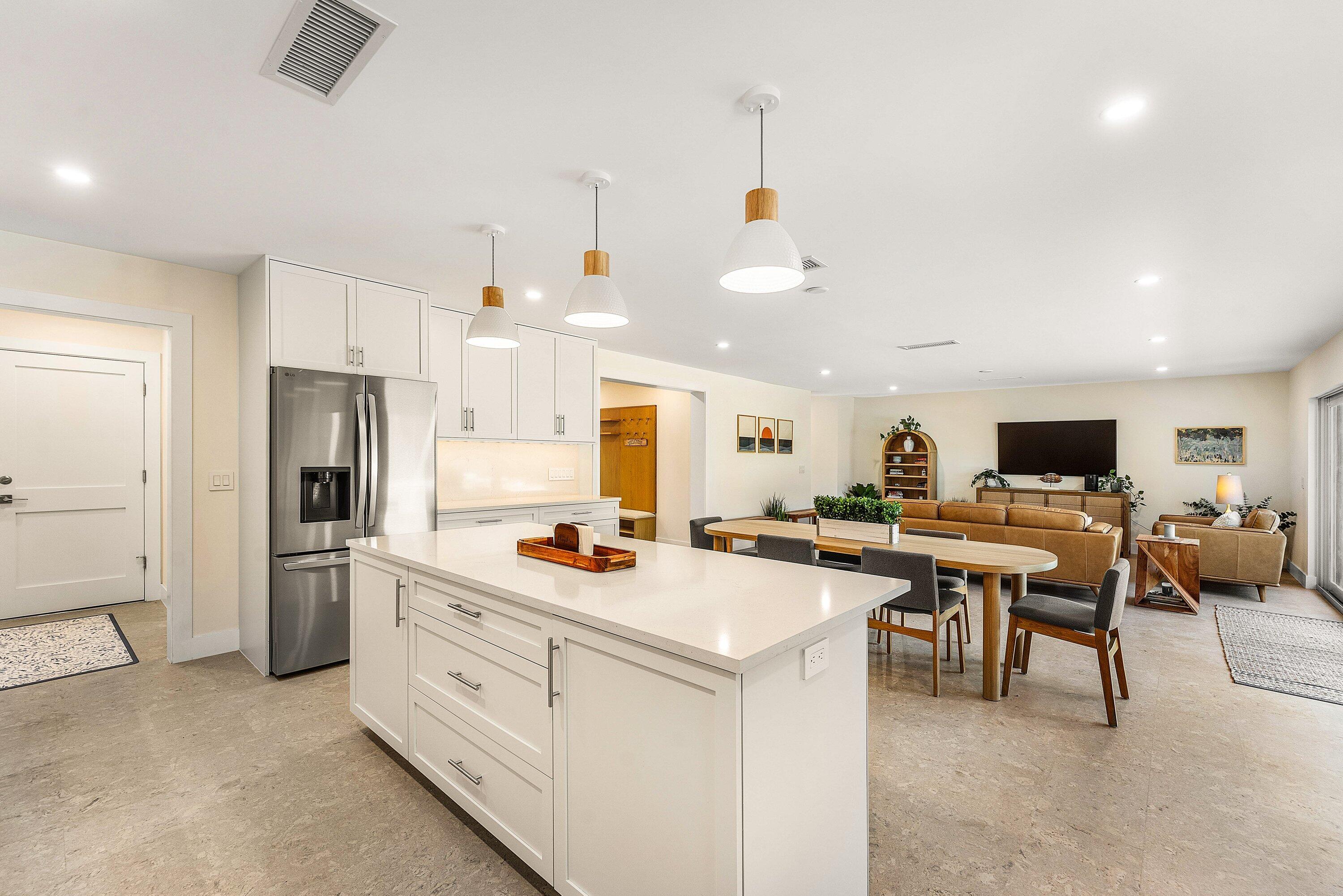 1070 Marble Way Boca Raton, FL 33432 - Photo 12 of 39 a view of a kitchen with kitchen island a stove a refrigerator a sink dishwasher with a dining table and chairs