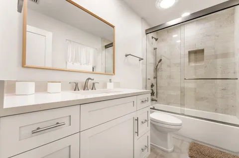 a bathroom with a sink a toilet and shower