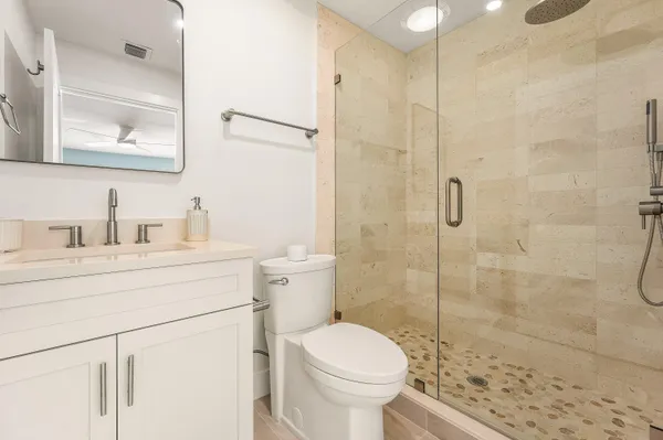 a bathroom with a sink toilet and shower